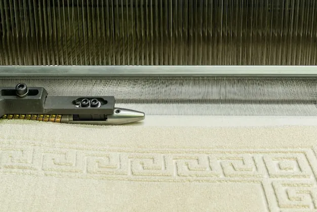 Cream jacquard terry with a Greek-key border coming off a loom