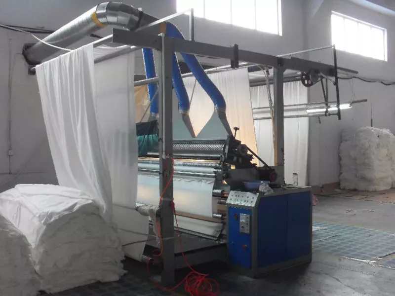 White terry fabric running through a finishing machine